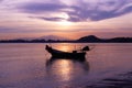 Boat of fisherman on the beach with silhouette light before sunset and mountain background Asia Thailand Royalty Free Stock Photo