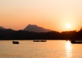 Boat fisherman silhouette at sunset on mekong river Royalty Free Stock Photo