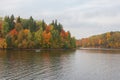 Boat with fishermen fishing in the Perse river in Koknese in colorful autumn Royalty Free Stock Photo