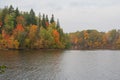 Boat with fishermen fishing in the Perse river in Koknese in colorful autumn Royalty Free Stock Photo