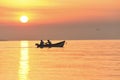 Boat with fishermen in the sea at sunrise, sunset