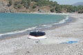 Fishing boat and net lie on the beach, Calis, Fethiye, Turkey. Royalty Free Stock Photo
