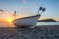 Boat fishing . wooden boat . old boat . sunset boat . sunset beach . beach sand . boat in beach sand . boat in mediterranean sea . Royalty Free Stock Photo