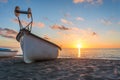 Boat fishing . wooden boat . old boat . sunset boat . sunset beach . beach sand . boat in beach sand . boat in mediterranean sea . Royalty Free Stock Photo