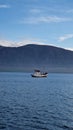 Boat floating in sea in background of hill