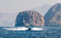 Boat floating on seaside surrounded by desert rocks near Khasab Oman Royalty Free Stock Photo