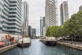 Boat in water with modern buildings in Canary Wharf Royalty Free Stock Photo