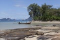 The boat floats on the background of the beautiful island.Traditional Thai Fishing boats with colorful ribbons and flags. Thailand