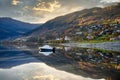 A boat floats in a lake in Voss, Norway, the still water looks like a mirror