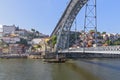 The boat floats on the river Douro under the bridge Dom Luis I Bridge. Scenic view of Ribeira from Vila Nova de Gaia. Porto, Royalty Free Stock Photo