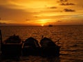 The boat floats at sea at sunset Royalty Free Stock Photo