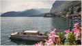 A boat and flowers on the beach. Lake Como, Italy