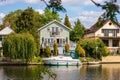 Boat in front of summer house on Thames River, England Royalty Free Stock Photo