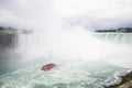 Boat full of tourists move towards niagara falls