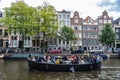 Boat full of young people along the canal in Amsterdam, Netherlands Royalty Free Stock Photo