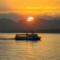 Boat glides under sunsets golden glow on Lake Baikal Royalty Free Stock Photo