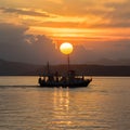 Boat glides under sunsets golden glow on Lake Baikal Royalty Free Stock Photo