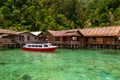 Boat on the green coral ocean in Sawai, Maluku, Indonesia Royalty Free Stock Photo