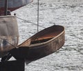 Boat hangs above the water on a steel chain overboard