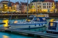 Boat in the harbor of Vlissingen with lighted city view, popular city in zeeland at night, The Netherlands