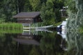 Boat house and boat reflecting on lake Royalty Free Stock Photo