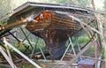 Boat house that collapsed over a wooden boat Royalty Free Stock Photo