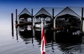 Boat houses are reflected in waters of Alberni Inlet