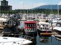 Boat houses on the water of Coal Harbour Marina. Royalty Free Stock Photo