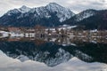The boat huts are reflected in the Schliersee