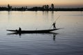 A boat and its crew are silhouetted against the River Bani at dusk in Mopti, Mali