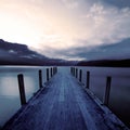 Boat jetty and a calm lake at sunrise, New Zealand. Royalty Free Stock Photo