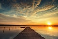 Boat and jetty on lake with a reflection in the water at sunset Royalty Free Stock Photo