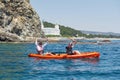 Boat kayaking near cliffs on a sunny day. Kayaking in a quiet bay. Amazing views. Travel, sports concept. Lifestyle. A