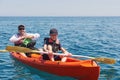 Boat kayaking near cliffs on a sunny day. Kayaking in a quiet bay. Amazing views. Travel, sports concept. Lifestyle. A