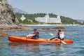 Boat kayaking near cliffs on a sunny day. Kayaking in a quiet bay. Amazing views. Travel, sports concept. Lifestyle. A