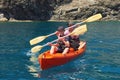 Boat kayaking near cliffs on a sunny day. Kayaking in a quiet bay. Amazing views. Travel, sports concept. Lifestyle. A