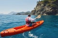 Boat kayaking near cliffs on a sunny day. Travel, sports concept. Lifestyle