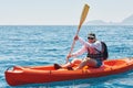 Boat kayaking near cliffs on a sunny day. Travel, sports concept. Lifestyle