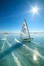 Boat for kitewing frozen ice on a beautiful lake on a background of blue sky Royalty Free Stock Photo