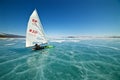 Boat for kitewing frozen ice on a beautiful lake on a background of blue sky Royalty Free Stock Photo
