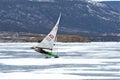 Boat for kitewing frozen ice on a beautiful lake on a background of blue sky Royalty Free Stock Photo