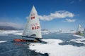 Boat for kitewing frozen ice on a beautiful lake on a background of blue sky Royalty Free Stock Photo