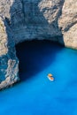 A boat in the lagoon near Navagio Beach, Zakynthos Island, Greece. View of the sea bay and a lone boat from a drone. Blue sea wate Royalty Free Stock Photo