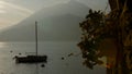 Boat on Lake Como at the sunset. Silver linings in Lake Como at the sunset. Royalty Free Stock Photo