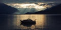 Boat on Lake Como at the sunset. Silver linings. Royalty Free Stock Photo