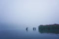 Boat on the lake at morning fog. Foggy autumn Royalty Free Stock Photo