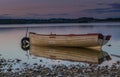 Boat on the lake with reflection in the water at sunset. Lough Owell lake