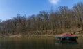 Boat on a lake surrounded by the Maksimir Park covered in trees in Zagreb in Croatia