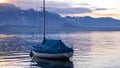 Boat on a lake in Switzerland, with a snowy mountain and clouds in the background.