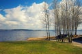 Boat at the lake through the trees on a sunny spring day Royalty Free Stock Photo